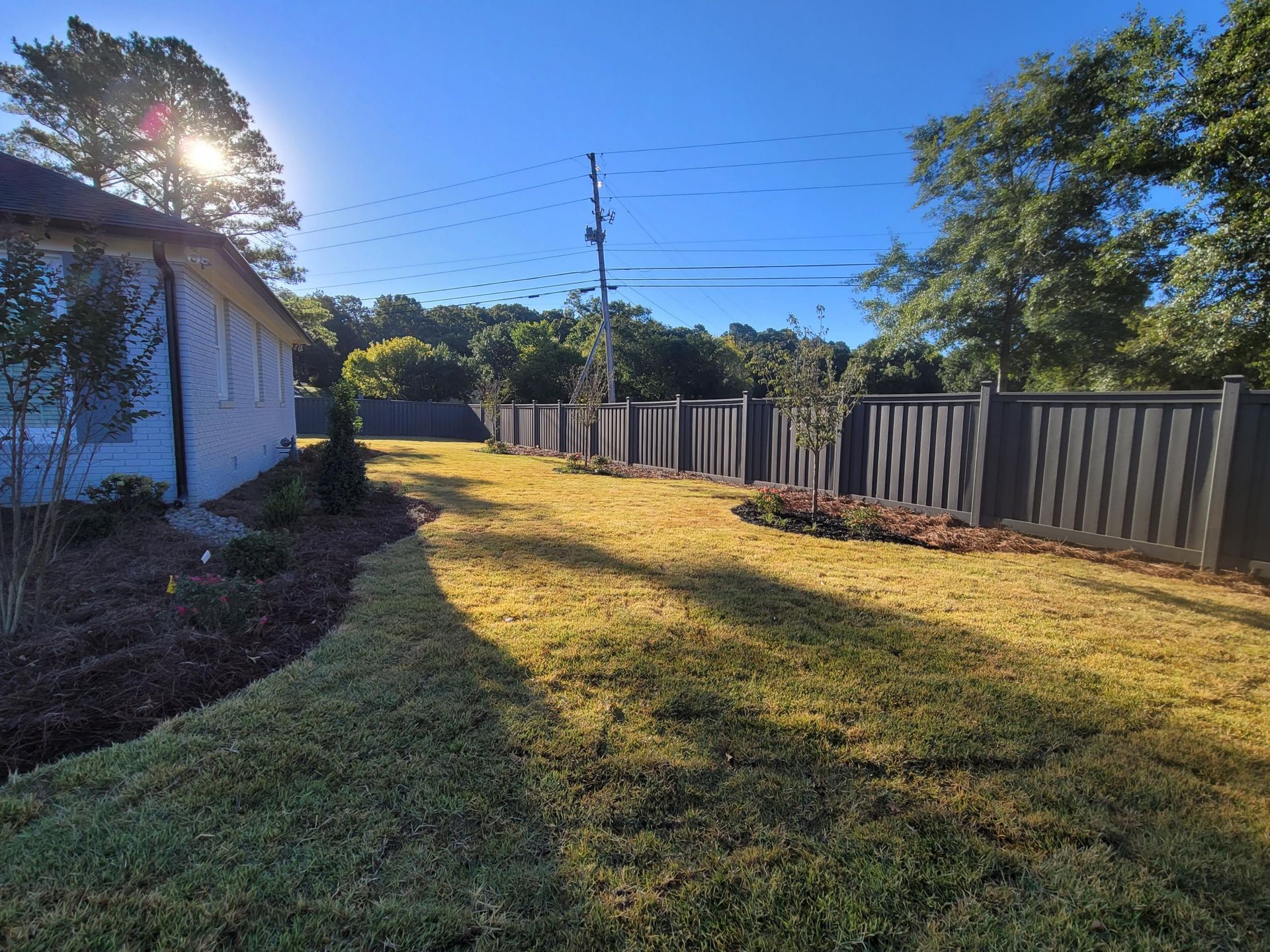 Ornamental fence and gate installation at a residential entrance